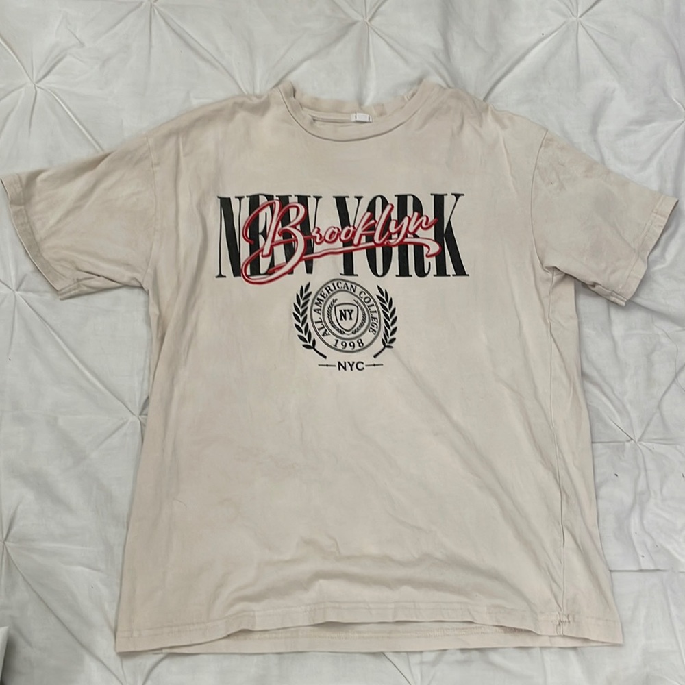 Tan Garage short-sleeve tee with graphic design on the front